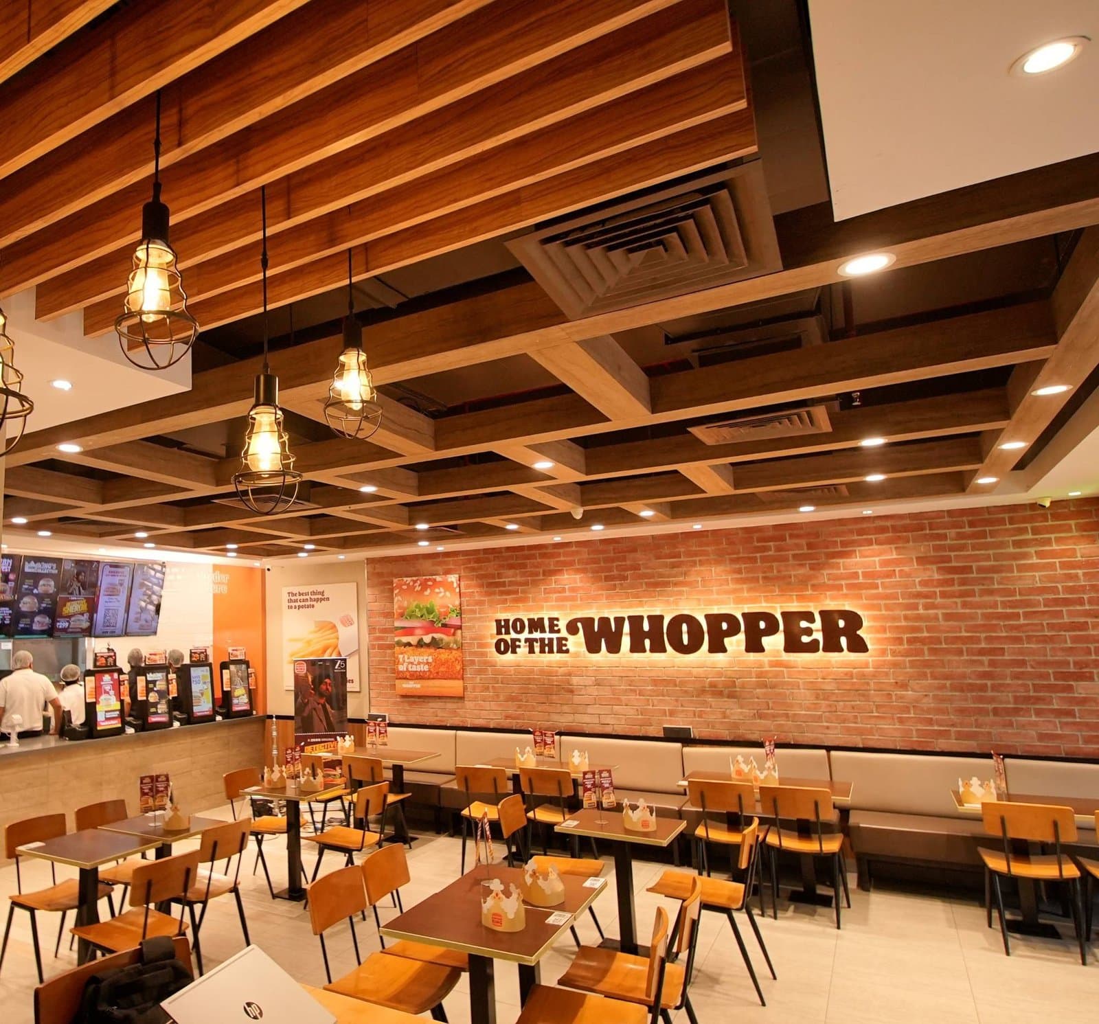 Burger King dining area with the Home of the Whopper wall sign
