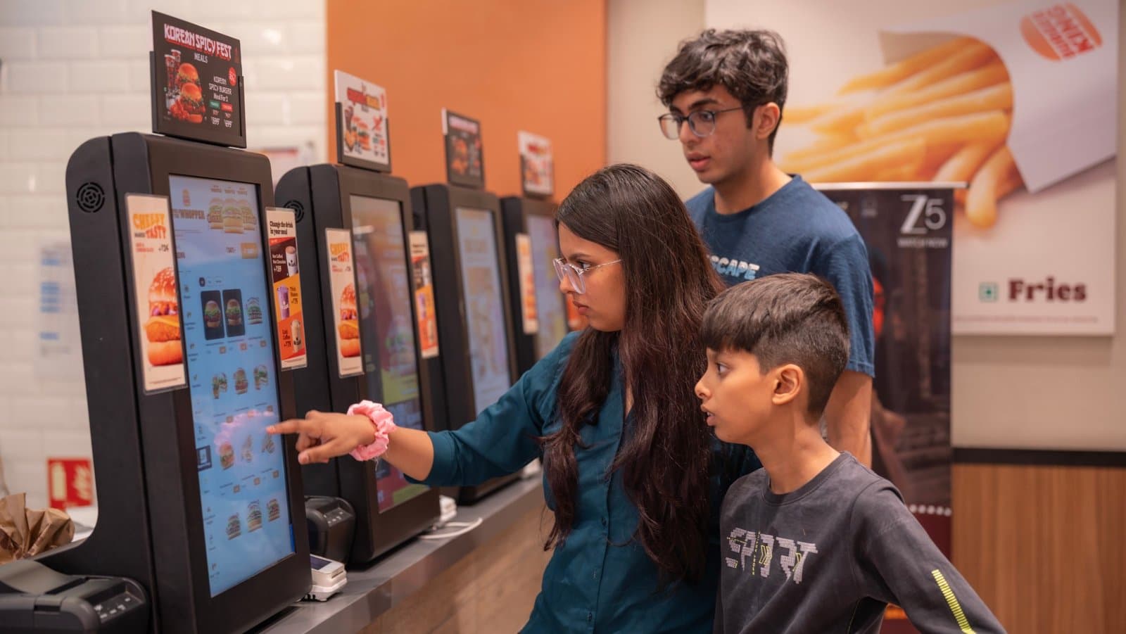 Guests ordering at a Burger King self-order kiosk